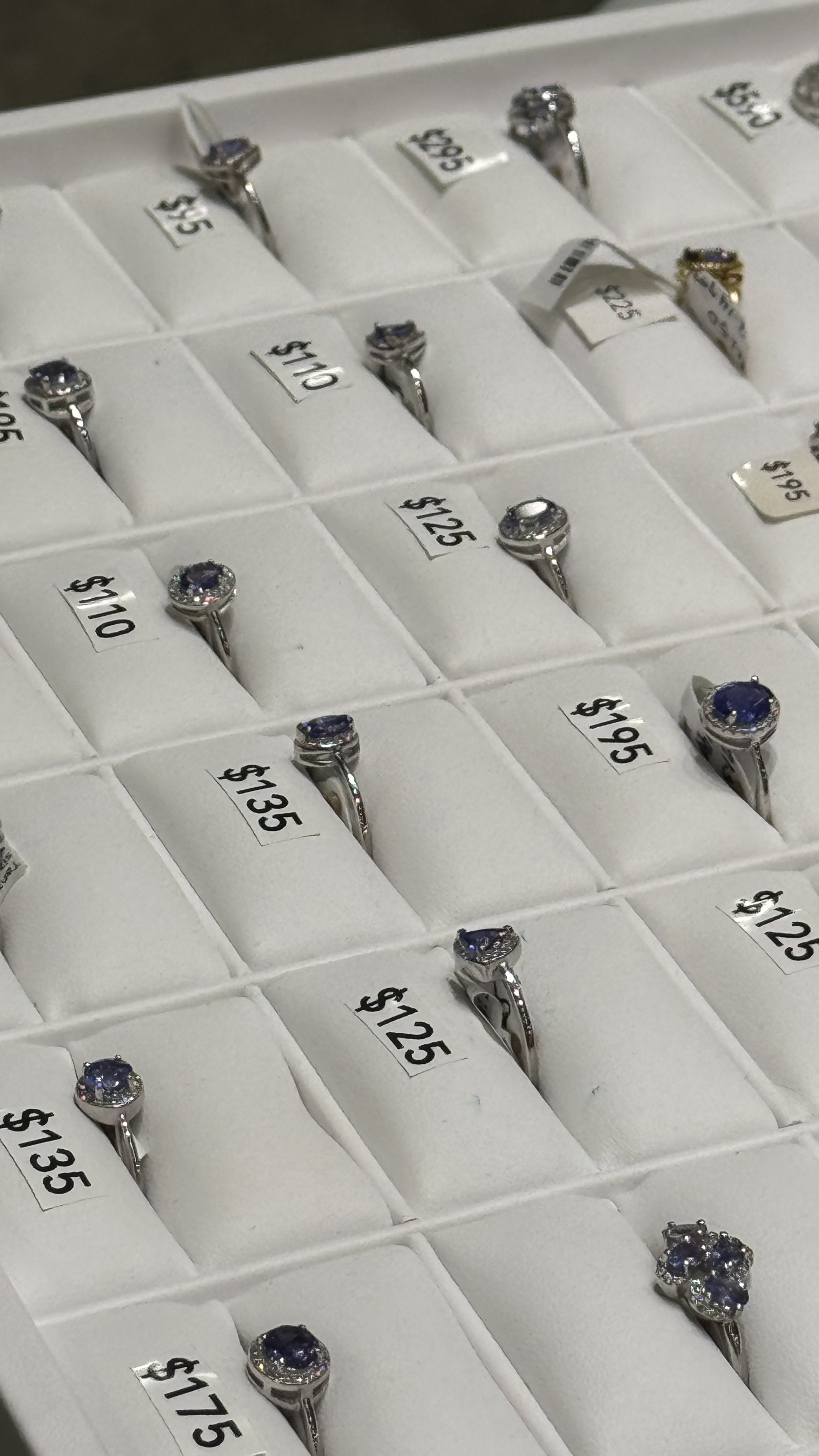 Tanzanite rings collection with price tags in Stone Town jewelry store