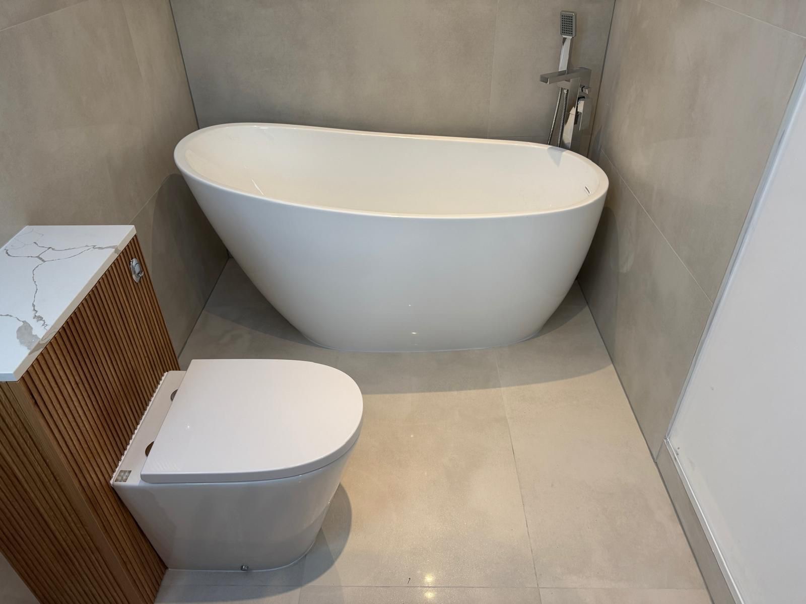 Modern bathroom with freestanding bathtub and vanity unit
