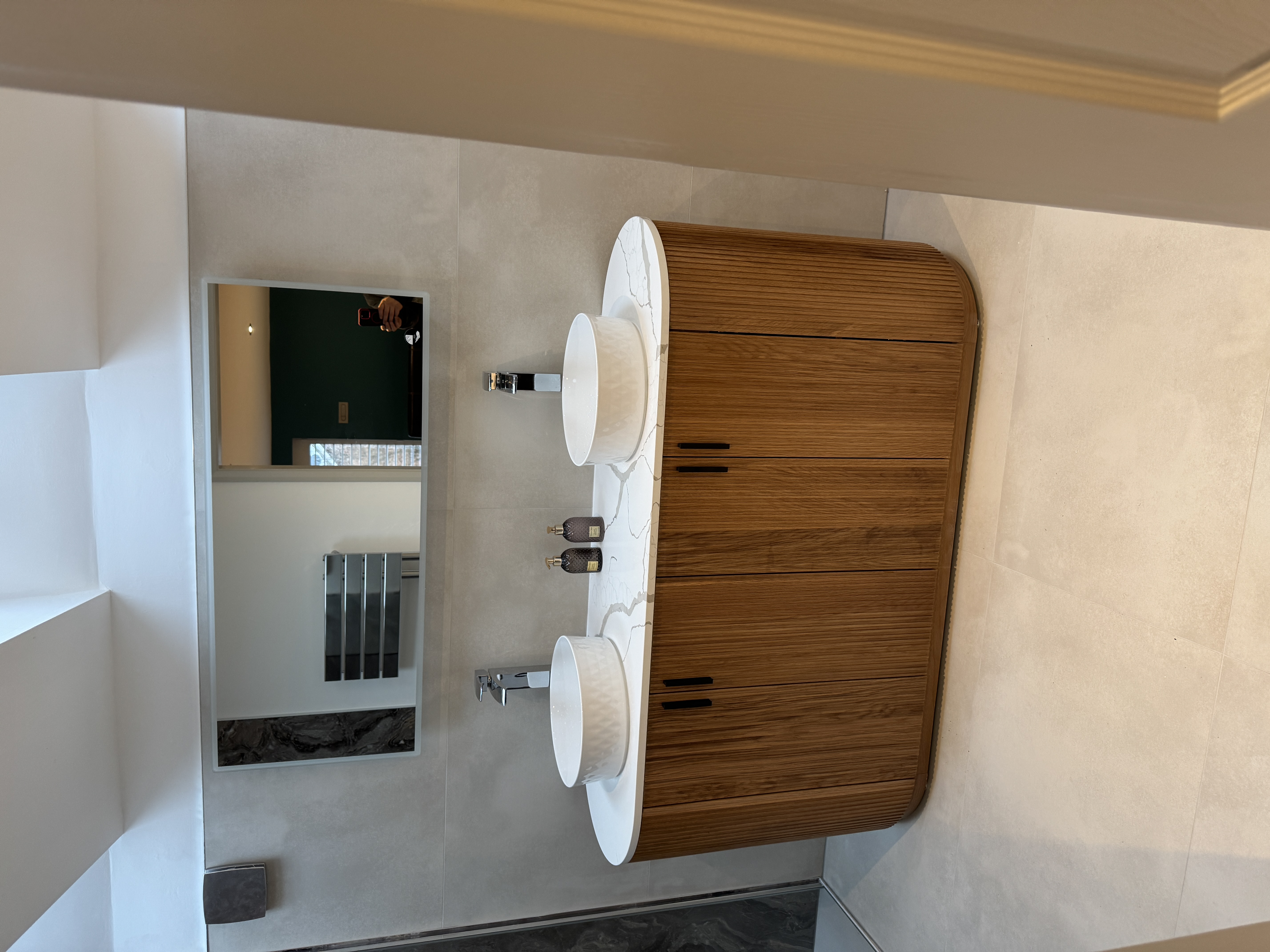 Double vanity bathroom with vertical slatted wood cabinet