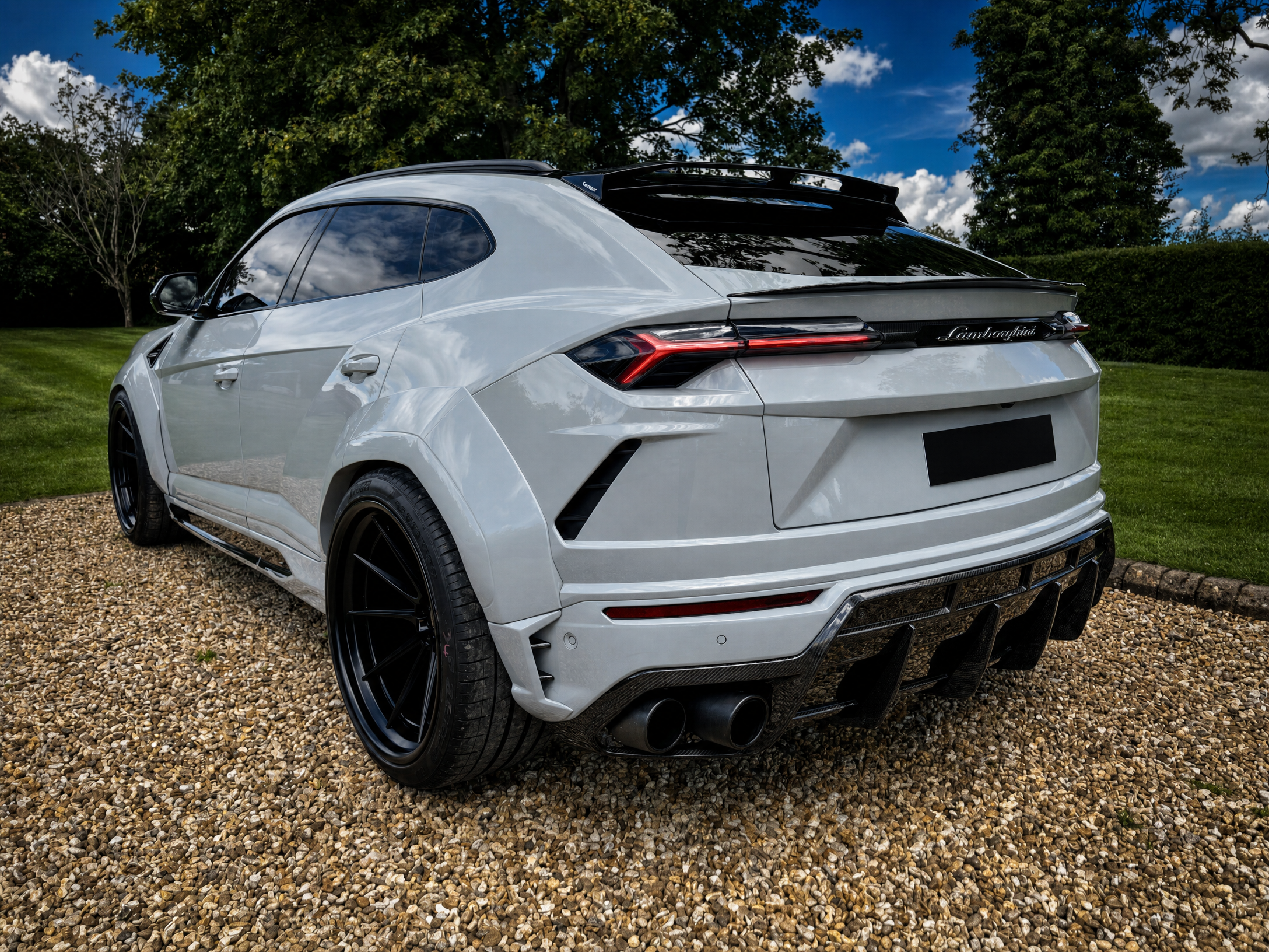 Lamborghini Urus — rear three-quarter showing the widebody stance