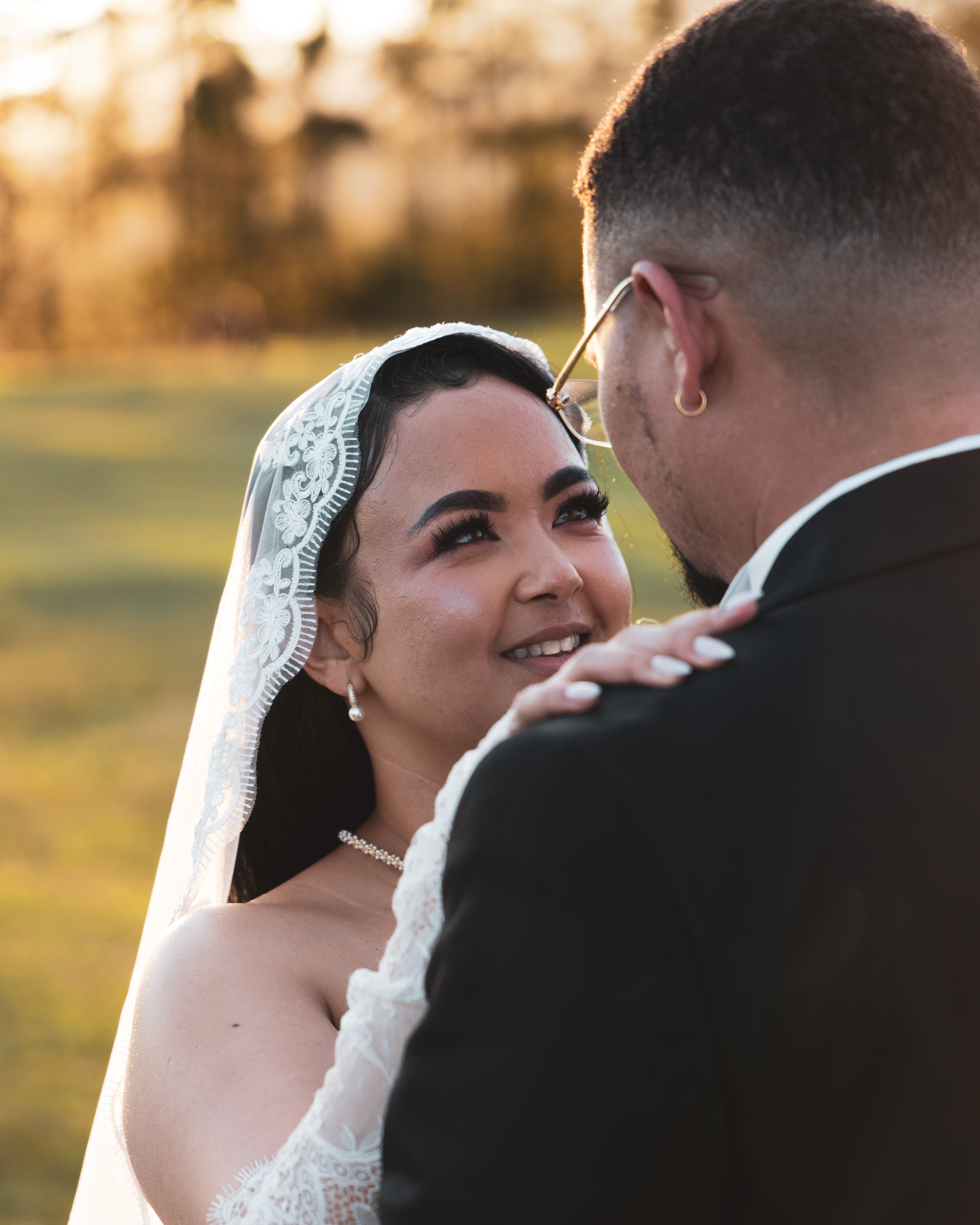 Bride gazing lovingly at groom during golden hour