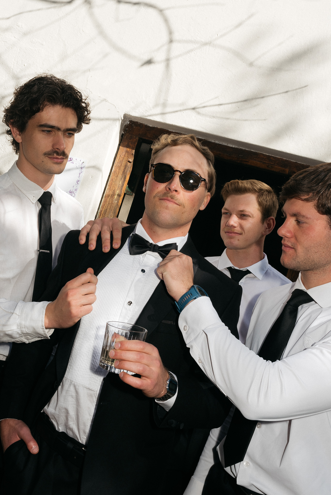 Groom and groomsmen looking sharp in black tie