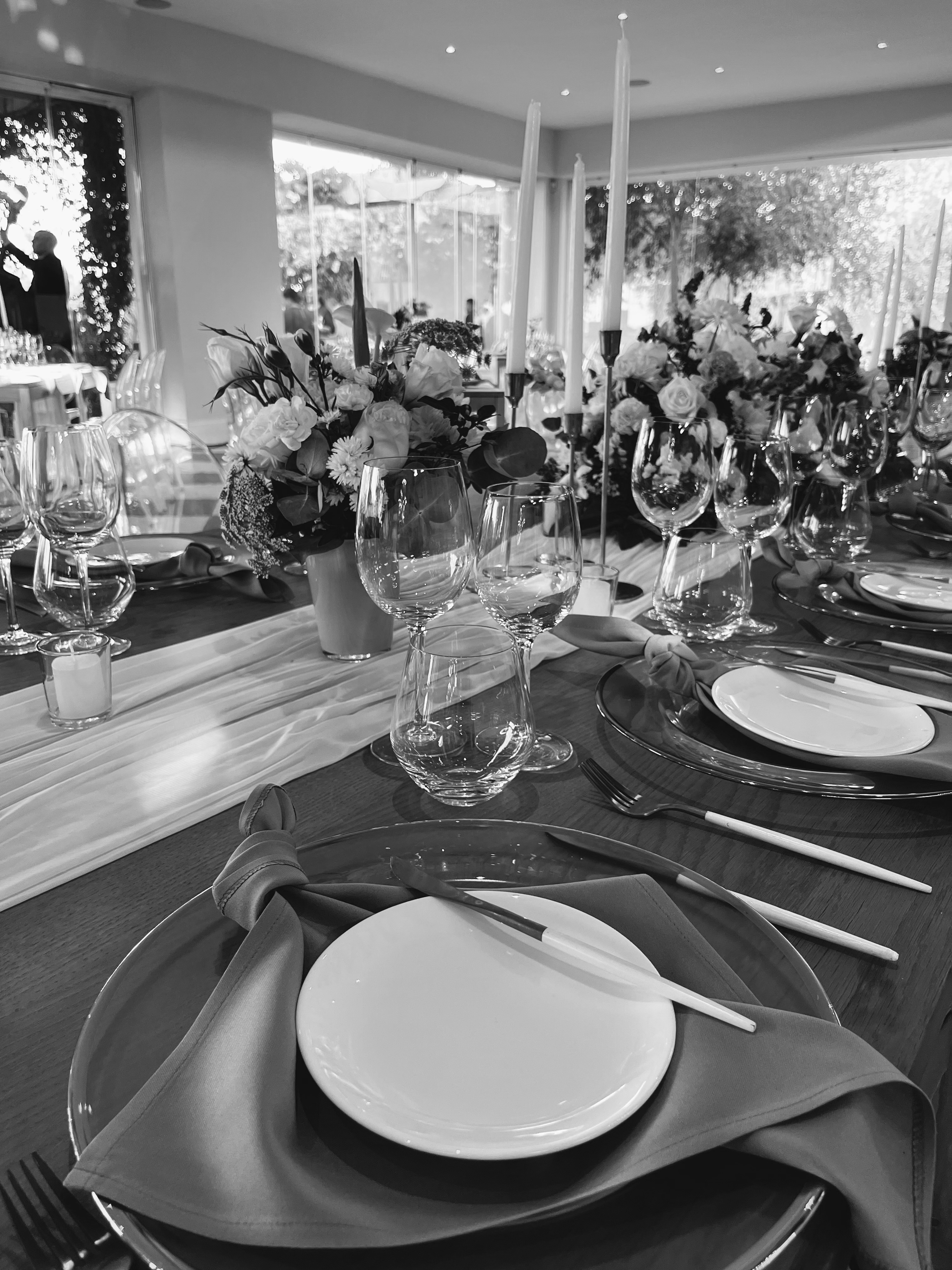 Elegantly styled table setting with floral arrangements and taper candles
