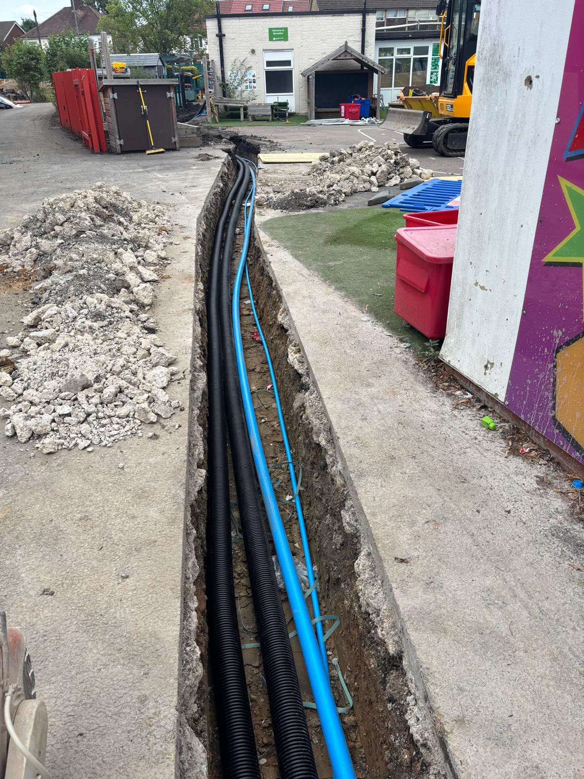 Drainage and utility installation between buildings Central London School
