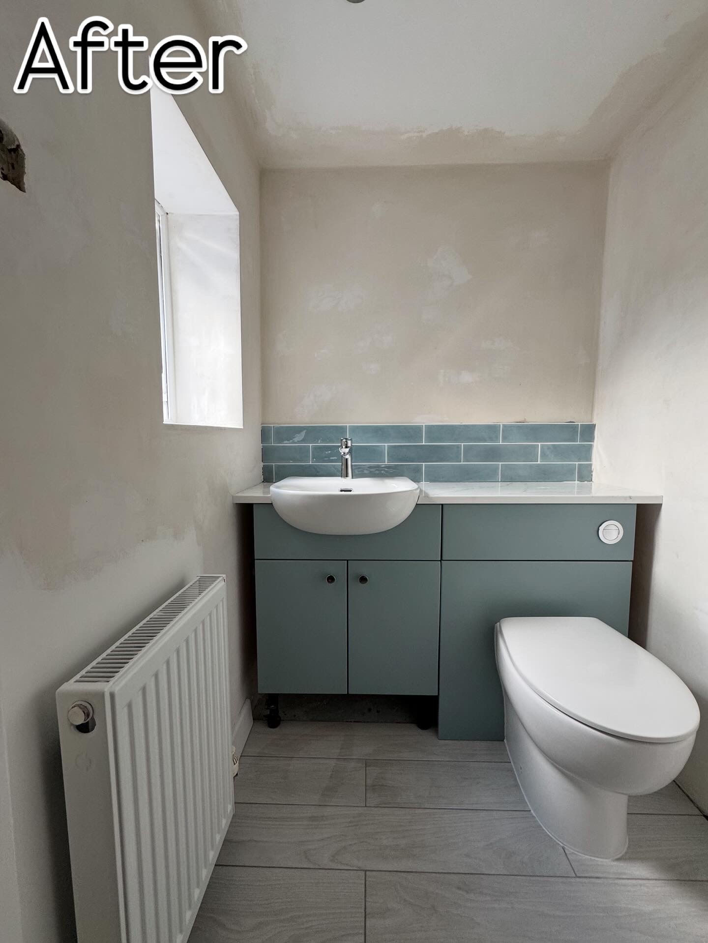 Cloakroom bathroom with sage green vanity unit, blue subway tile splashback, and grey floor tiles