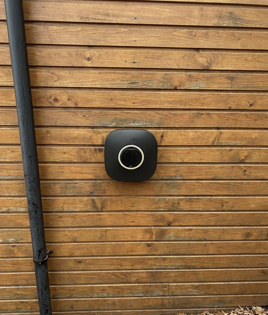 Rolec EVO EV charger with LED status ring installed on timber cladding by Power Team Electrics