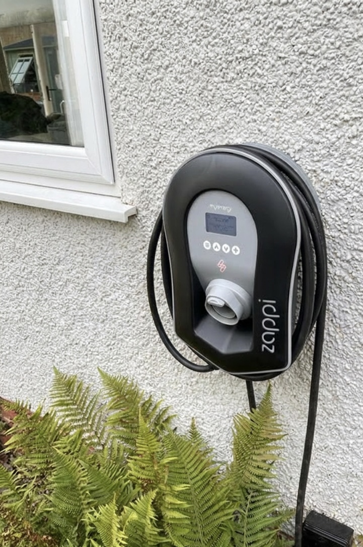 Myenergi Zappi EV charger installed on pebbledash wall by Power Team Electrics, solar-compatible EV charger