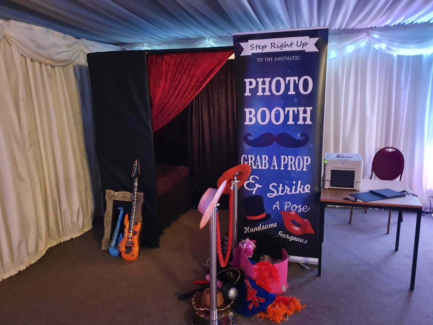 Pose Photo Booth set up at a venue with banner, props and printer ready for guests
