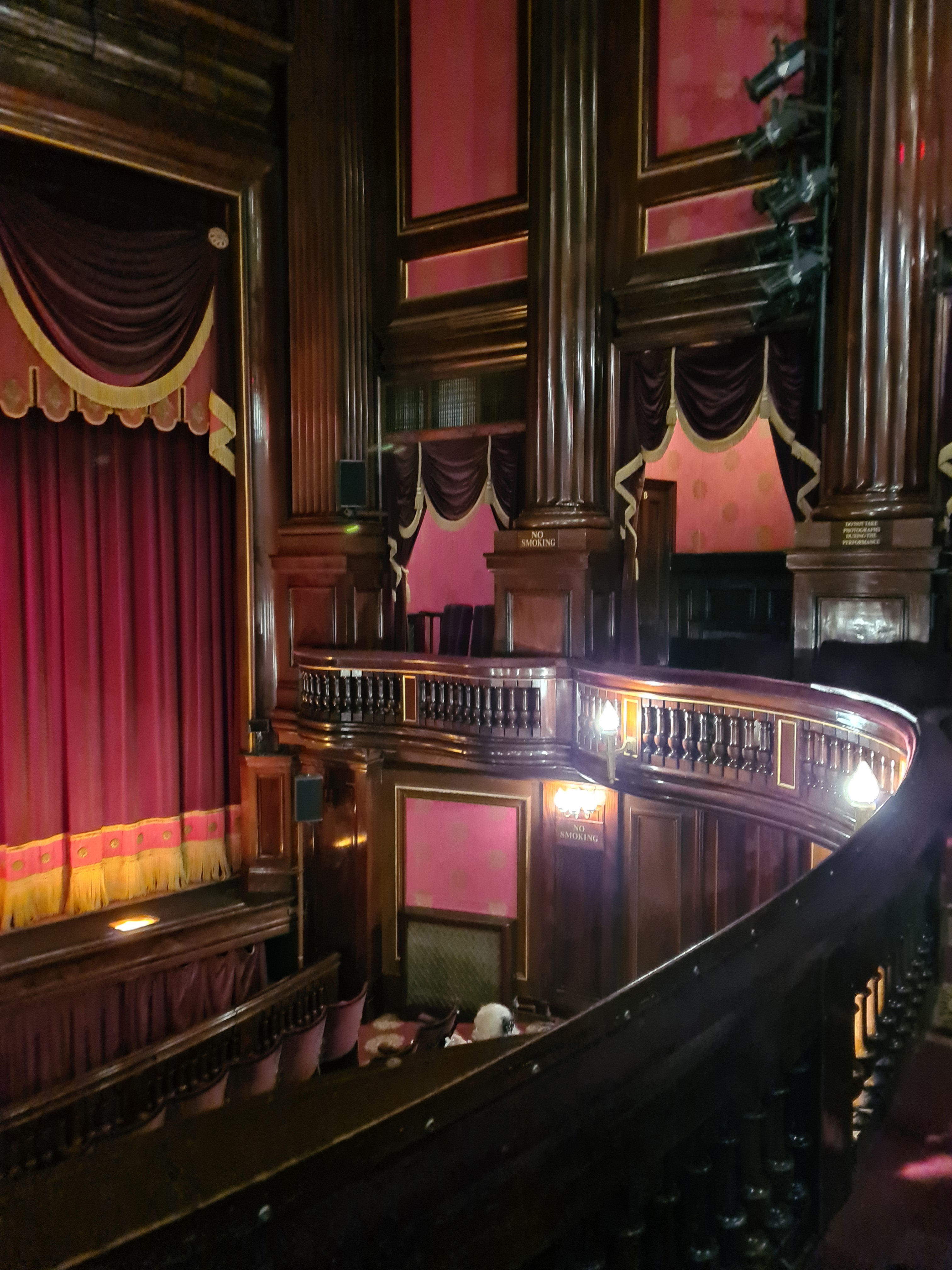 Front-of-house staff directing a guest with a disability to an accessible entrance at a West End theatre