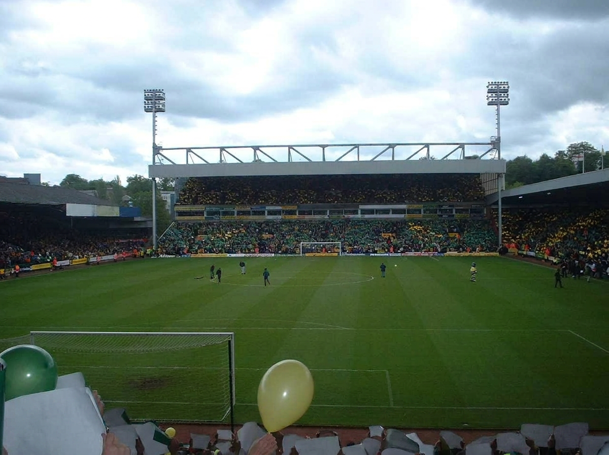 Wheelchair user and companion entering accessible stadium entrance on matchday